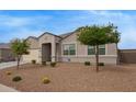 Charming single-story home featuring well-manicured desert landscape and a two-car garage at 3818 N 306Th Ave, Buckeye, AZ 85396