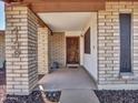 Charming front porch with brick columns, a decorative front door, and a welcoming entrance at 4139 W Anderson Dr, Glendale, AZ 85308