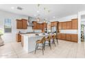 Spacious kitchen featuring an island with seating, stainless steel appliances, and modern pendant lights at 4247 S Zenith --, Mesa, AZ 85212