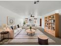 Bright living room featuring neutral decor and a decorative bookshelf at 44271 W Oster Dr, Maricopa, AZ 85138