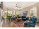 Cozy living room with wood-look tile floors, ceiling fan, and ample natural light at 4516 E Walter Way, Phoenix, AZ 85050