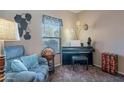 Comfortable bonus room with a piano, globe, and cozy blue recliner at 5139 W Shumway Farm Rd, Laveen, AZ 85339