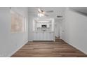 View of open kitchen with white cabinets, stone countertops, stainless appliances and wood floors at 520 N Stapley Dr # 123, Mesa, AZ 85203