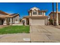 Charming home with a two-car garage, tile roof and a green lawn at 6857 S Roosevelt St, Tempe, AZ 85283