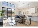 Bright living room with modern furnishings, glass coffee table, and access to an outdoor patio at 7955 E Chaparral Rd # 116, Scottsdale, AZ 85250