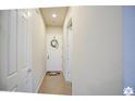 Bright hallway featuring neutral walls, tile flooring, and a welcoming white front door at 846 N Pueblo Dr # 119, Casa Grande, AZ 85122