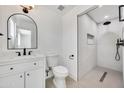 Modern bathroom showcasing a sleek vanity, toilet, and luxurious glass-enclosed shower with black hardware at 132 W Orchid Ln, Chandler, AZ 85225