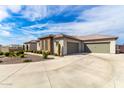 A wide driveway and multiple garage doors highlight the house's exterior at 216 W Paoli St, San Tan Valley, AZ 85143