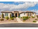 Inviting front exterior with desert landscaping, a brick-accented entrance, and a well-manicured yard at 216 W Paoli St, San Tan Valley, AZ 85143