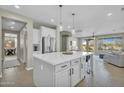 Open concept kitchen with island, pendant lighting, and easy access to dining and living areas at 27954 N Sierra Sky Dr, Peoria, AZ 85383