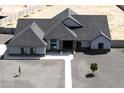Expansive single-story home featuring a modern design, complemented by a durable roof and low-maintenance gravel landscaping at 34949 N Donald Way, San Tan Valley, AZ 85140