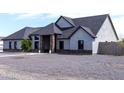 A contemporary home with stone accents, a gravel yard, and modern windows adds curb appeal at 34949 N Donald Way, San Tan Valley, AZ 85140