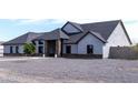 Stunning single-story home with elegant stone pillars, a charming walkway, and a minimalist gravel front yard at 34949 N Donald Way, San Tan Valley, AZ 85140