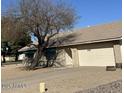 Single-story home with a two-car garage and low-maintenance front yard landscape at 4741 W Annette Cir, Glendale, AZ 85308