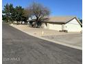 This house features a well-manicured landscape and attached two-car garage at 4741 W Annette Cir, Glendale, AZ 85308