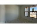 A new construction bedroom featuring a pair of windows showing clear blue skies and neighborhood views at 11429 E Utah Ave, Mesa, AZ 85212