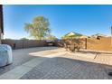 A spacious backyard features decorative brick ground covering and mature landscaping at 4056 E Rock Dr, San Tan Valley, AZ 85143