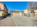 Lovely single-story home featuring a two-car garage, desert landscaping, and a neutral color palette at 4056 E Rock Dr, San Tan Valley, AZ 85143