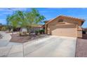Well-maintained home exterior with a spacious driveway and attached two-car garage at 5424 S 15Th St, Phoenix, AZ 85040