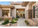 Inviting front entrance with stone accents and well-maintained landscaping at 7723 E Visao Dr, Scottsdale, AZ 85266