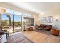 Spacious living room featuring large windows, hardwood floors, and outdoor views at 7723 E Visao Dr, Scottsdale, AZ 85266