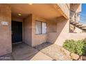 A welcoming view of the cozy front porch, stone landscaping and the front door to unit 113 at 10828 N Biltmore Dr # 113, Phoenix, AZ 85029