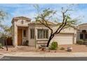 Single-story home featuring a landscaped front yard with mature tree and a brick driveway leading to an attached two-car garage at 12841 N 19Th St, Phoenix, AZ 85022