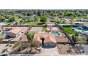 Aerial view of property featuring a pool, volleyball court, basketball court, lush landscaping and a private backyard oasis at 1289 E Palo Blanco Way, Gilbert, AZ 85296