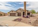 Charming single-story home features a three-car garage, desert landscaping, and a welcoming entrance at 14374 W Amelia Ave, Goodyear, AZ 85395