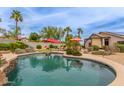 Resort-style pool features a water feature, lush landscaping, a mini-golf, and patio seating for outdoor entertainment at 14374 W Amelia Ave, Goodyear, AZ 85395