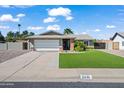 Inviting single-story home featuring a lush green lawn, a two-car garage, and a welcoming facade at 15430 N 51St Pl, Scottsdale, AZ 85254