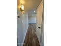 Hallway featuring durable and stylish wood flooring, leading to other areas of the home at 1615 W Michelle Dr, Phoenix, AZ 85023