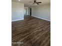 Spacious living room with abundant natural light, a ceiling fan, and attractive wood flooring at 1615 W Michelle Dr, Phoenix, AZ 85023