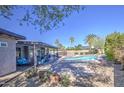 Relaxing backyard with a covered patio, sparkling pool, and lush landscaping for outdoor enjoyment at 1853 W Estrella Dr, Chandler, AZ 85224