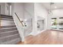 Bright foyer features hardwood floors, staircase, and a view of the pool through the French doors at 1920 E Belmont Dr, Tempe, AZ 85284