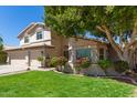 Inviting home with a well-manicured lawn, beautiful landscaping, and a spacious three-car garage at 1920 E Belmont Dr, Tempe, AZ 85284