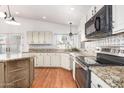 Well-appointed kitchen featuring an island, stainless appliances, and granite counters at 1920 E Belmont Dr, Tempe, AZ 85284