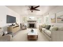Cozy living room with a brick fireplace, ceiling fan, neutral palette, and ample seating at 1920 E Belmont Dr, Tempe, AZ 85284