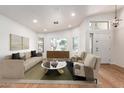 Bright living room features natural light, contemporary furnishings, and light hardwood floors at 1920 E Belmont Dr, Tempe, AZ 85284