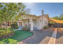 Charming home with a lush lawn, covered porch, and ample space for outdoor enjoyment at 2034 N Dayton St, Phoenix, AZ 85006