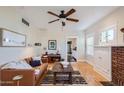 Bright living room with hardwood floors, a comfortable leather sofa, and a decorative fireplace at 2034 N Dayton St, Phoenix, AZ 85006