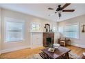 Inviting living room showcasing hardwood floors, a brick fireplace, and ample natural light at 2034 N Dayton St, Phoenix, AZ 85006