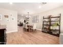 Open-concept dining room with a wooden table, stylish seating, and decorative shelving, perfect for entertaining at 2246 E Glenrosa Ave, Phoenix, AZ 85016