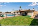 Private backyard featuring mature palm trees and a fenced pool area at 2541 E Inverness Ave, Mesa, AZ 85204