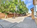 Spacious backyard featuring mature shade trees and a basketball hoop providing ample recreational space at 25453 N 68Th Ln, Peoria, AZ 85383