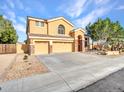 Charming home featuring a three-car garage, desert landscaping, and a well-maintained yard at 25453 N 68Th Ln, Peoria, AZ 85383