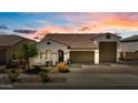 Charming single-story home featuring a tile roof, arched entryway, desert landscaping, and a two car garage at 25800 N 140Th Ln, Surprise, AZ 85387