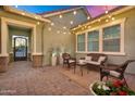 Relaxing outdoor patio area featuring wicker furniture and ambient string lights at 2617 S Jeffry St, Gilbert, AZ 85295