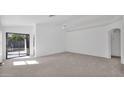 Bright and airy living room with sliding glass doors to a backyard at 3305 E Hononegh Dr, Phoenix, AZ 85050