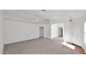 Spacious living room with neutral walls, carpet, and a ceiling fan for comfortable living at 3305 E Hononegh Dr, Phoenix, AZ 85050